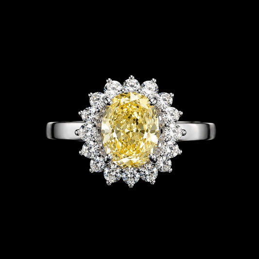A silver ring with a yellow CZ stone and clear CZ stones surrounding it.