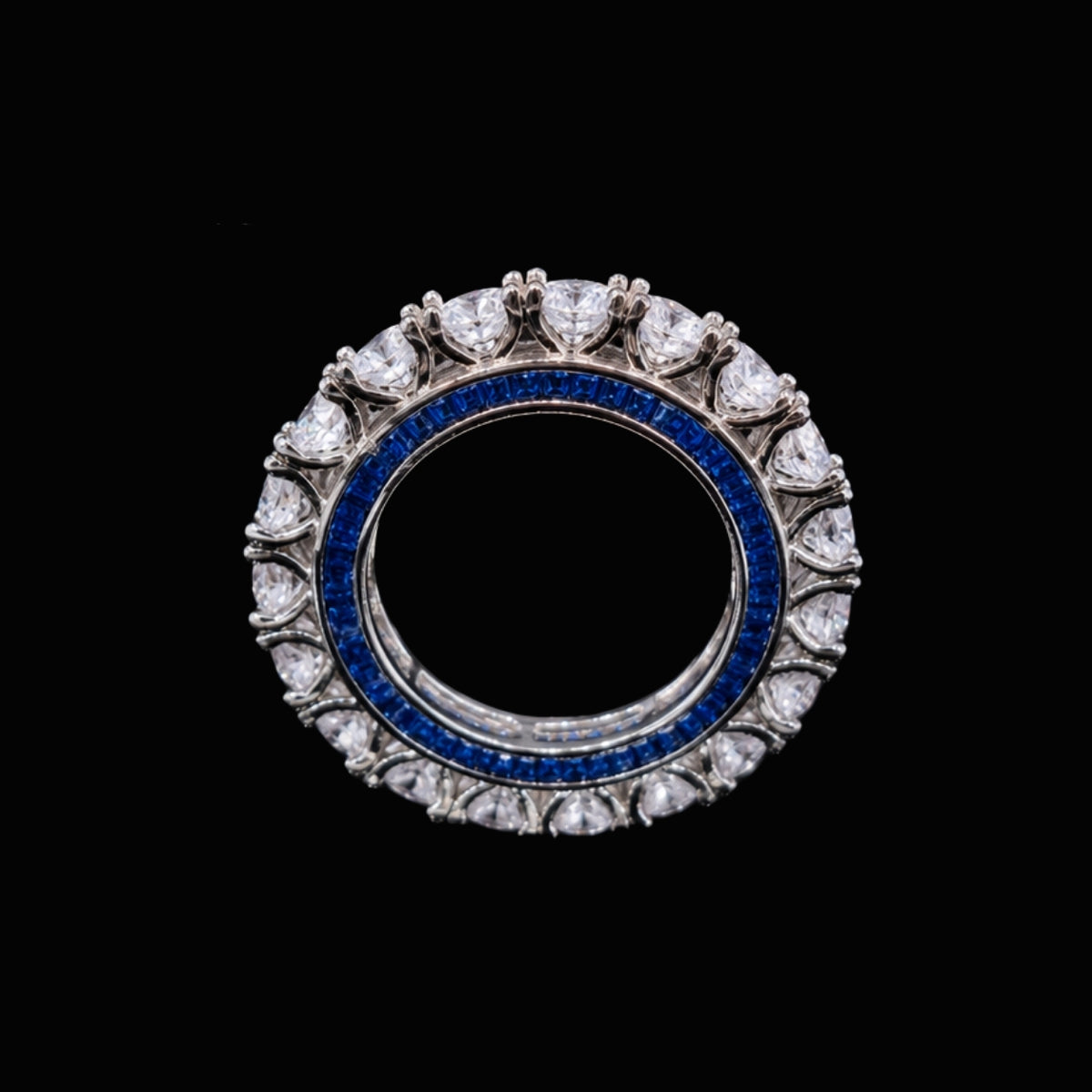 A silver-tone ring with a blue CZ stone surrounded by white CZ stones.