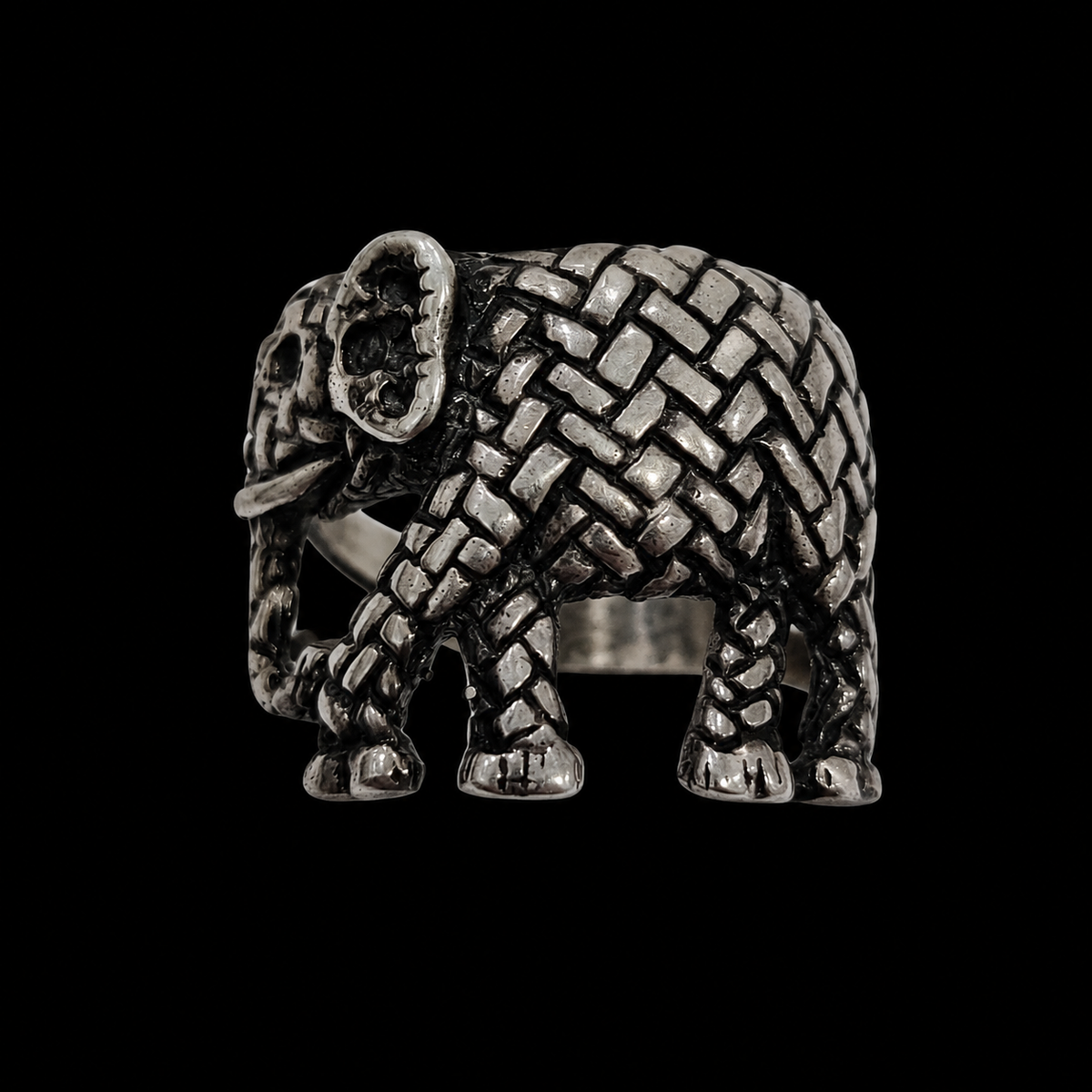 A silver ring with an intricately designed elephant motif, featuring CZ stones and an adjustable closure.