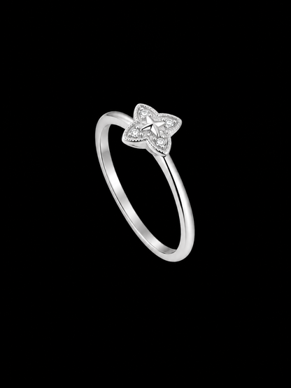 A silver ring with a star motif and CZ stones.