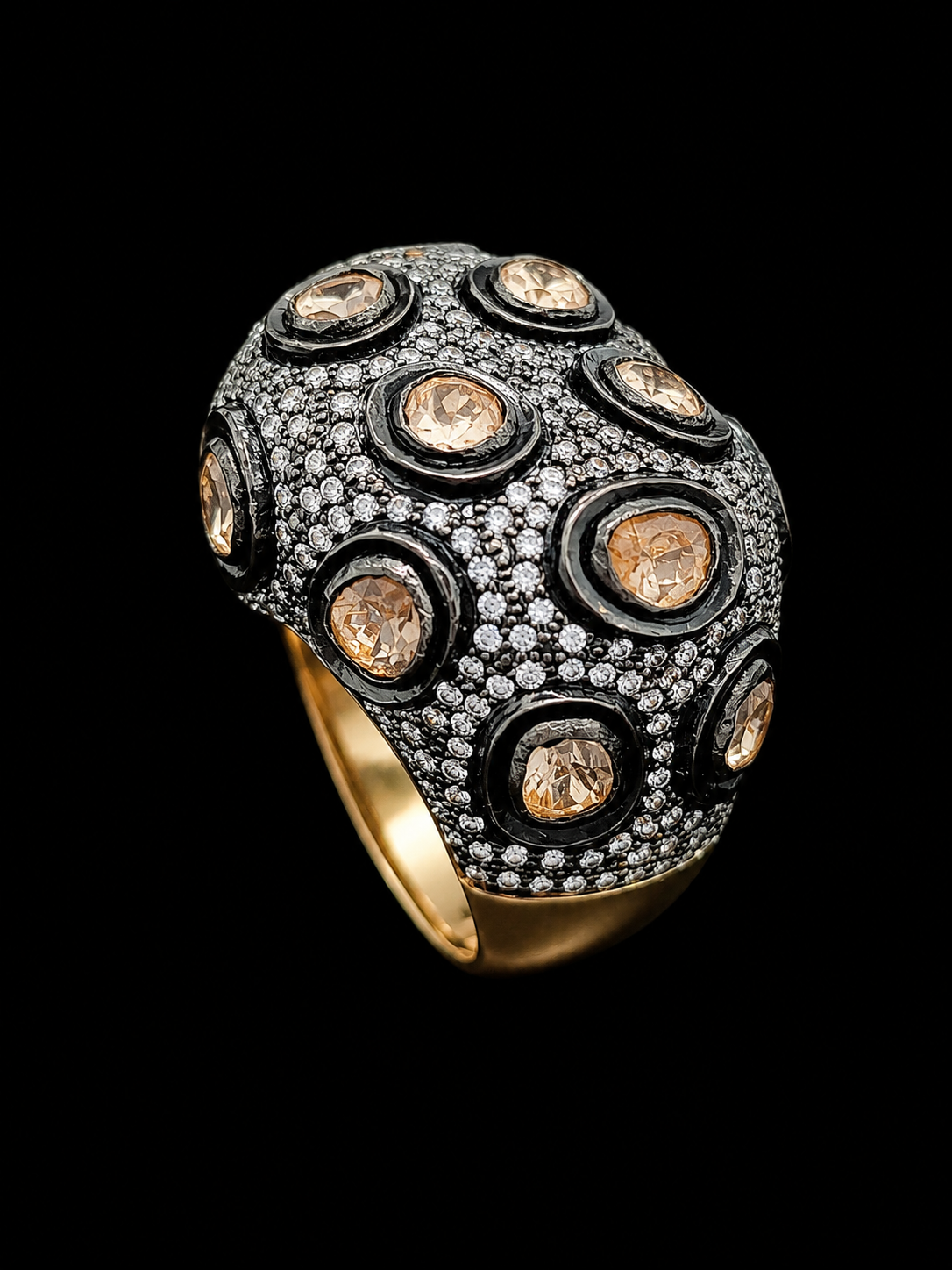 Gold and black ring with champagne CZ stones on a black background