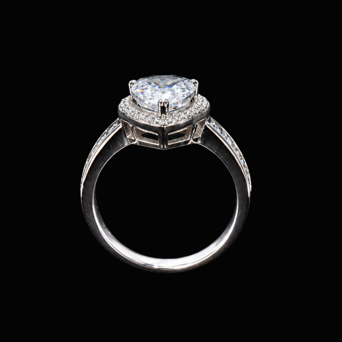 A silver ring with a large CZ stone and smaller accent stones, set against a plain background.