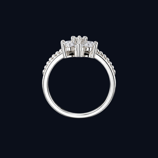 A silver ring with a cluster of clear cubic zirconia stones.