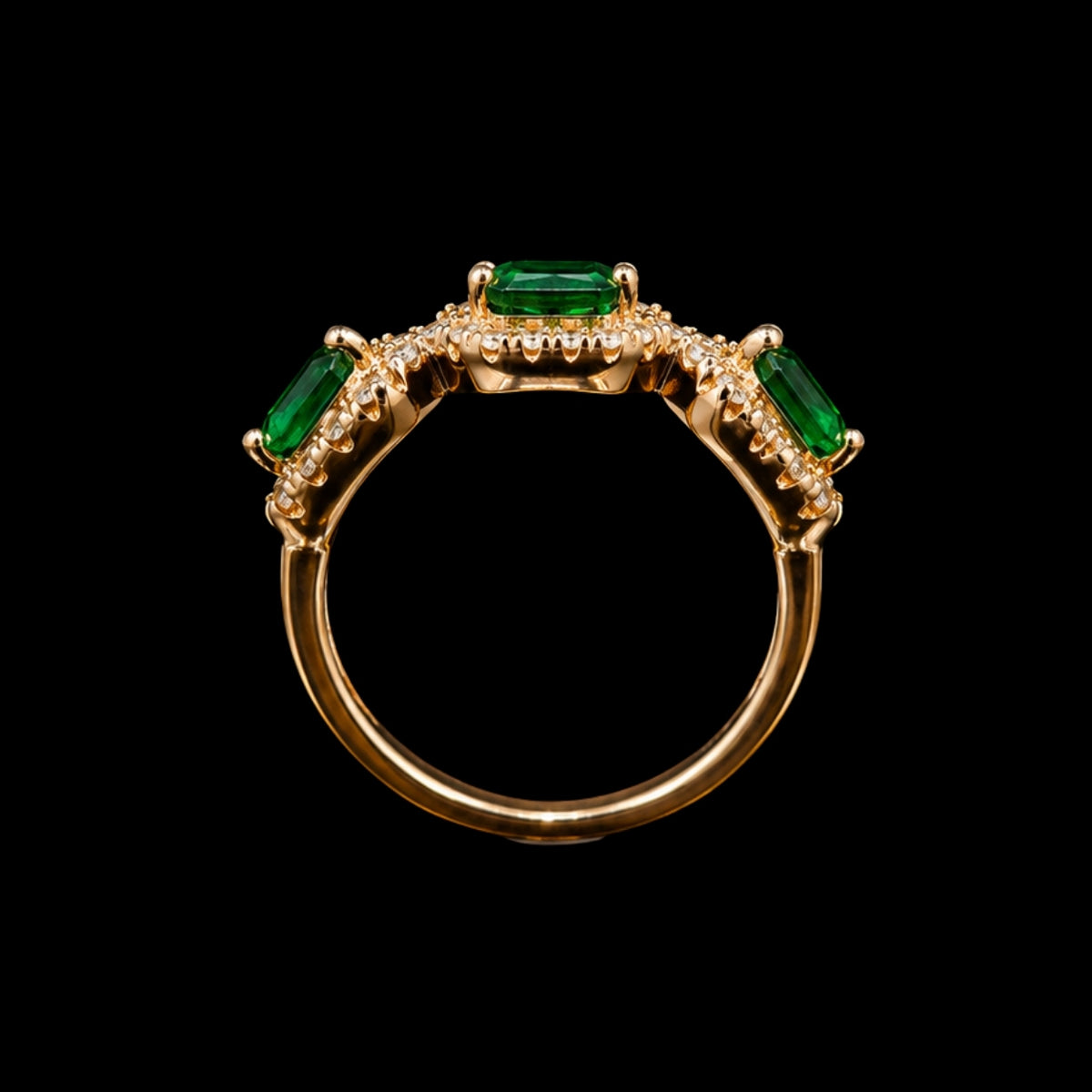 A gold-tone ring with three emerald-cut emeralds and clear cubic zirconia stones.