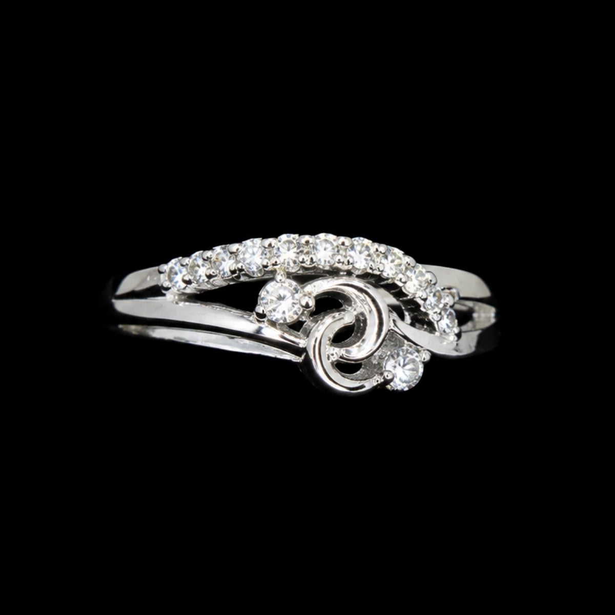 A silver ring with a swirl design and CZ stones.