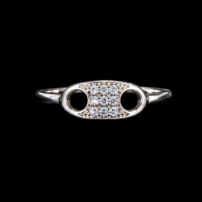 A silver ring with an oval motif and CZ stones.