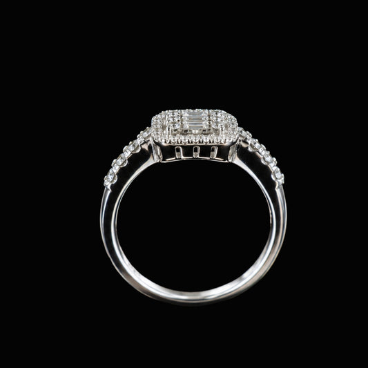 A silver ring with a central emerald-cut CZ stone and smaller round CZ stones, set in a delicate silver band.