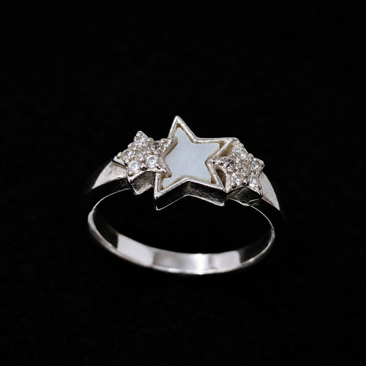 A silver-tone ring featuring two stars, one with white enamel and the other with CZ stones.