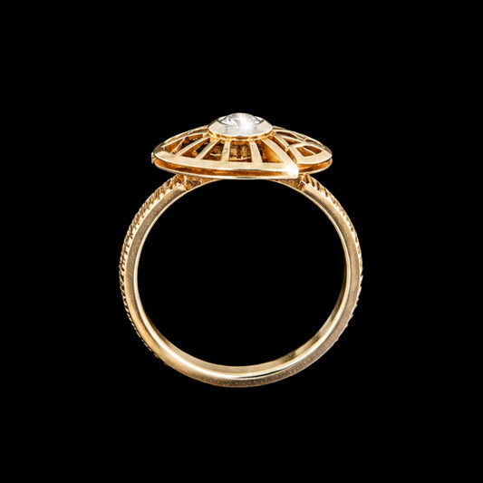 A gold ring with a round-cut CZ stone, set in a geometric design.