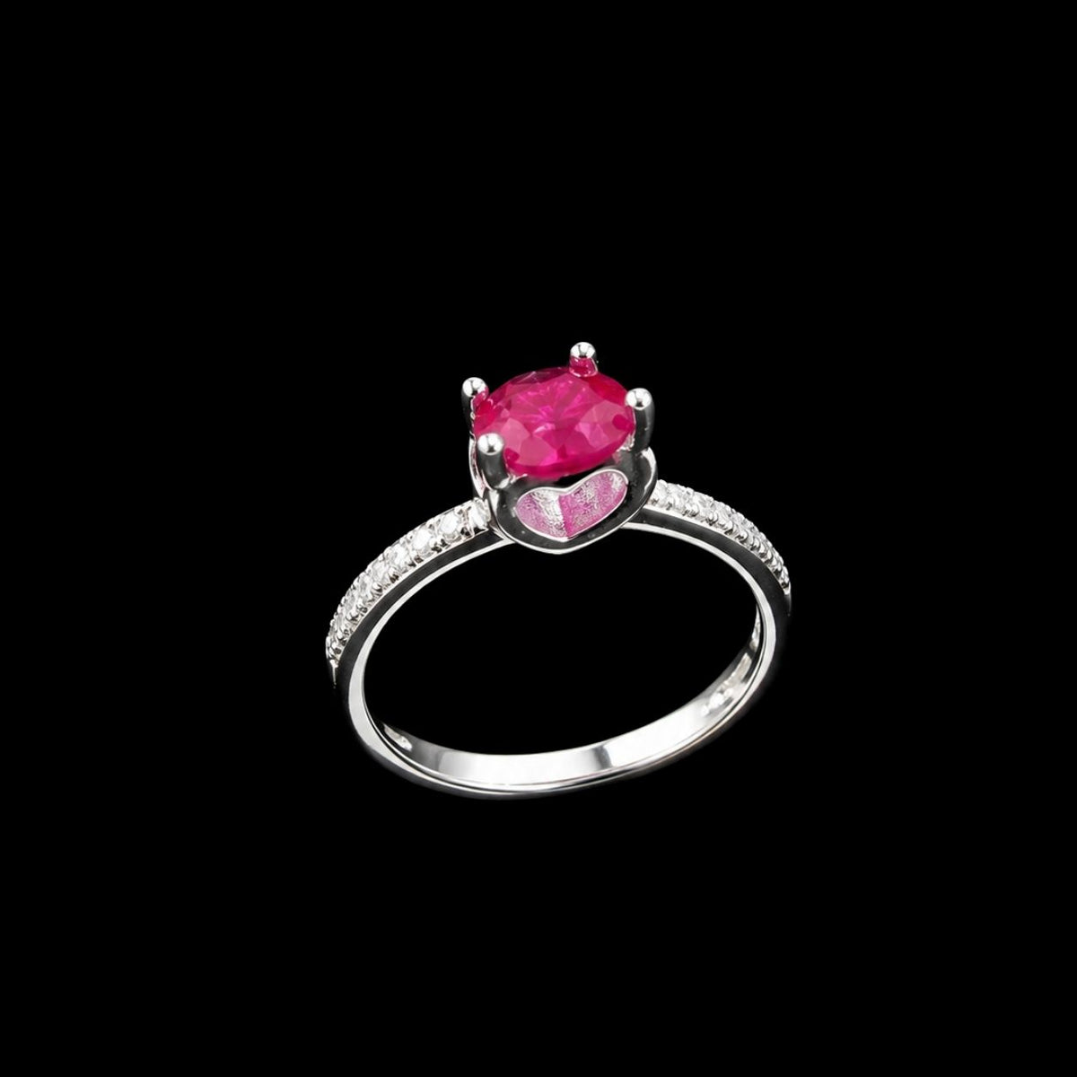 A silver-tone ring with an oval-cut ruby and CZ accents.