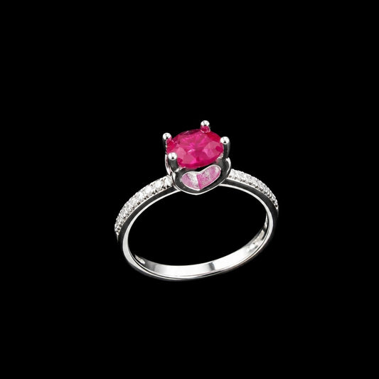 A silver-tone ring with an oval-cut ruby and CZ accents.