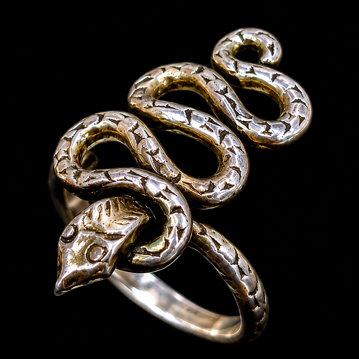 A silver and gold-tone snake ring with CZ stones.