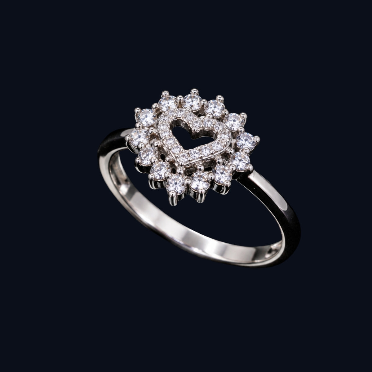 A silver-tone ring with a heart motif and CZ stones.