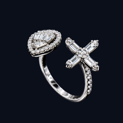A silver ring with a cross design and clear cubic zirconia stones.