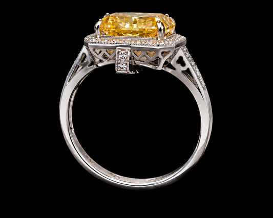 A silver ring with a large yellow CZ stone and intricate geometric design.