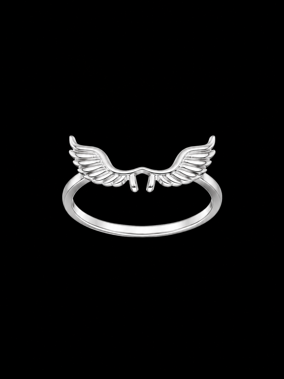 A silver ring with a wing design on a plain background