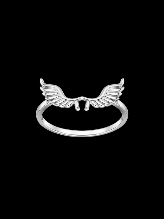 A silver ring with a wing design on a plain background
