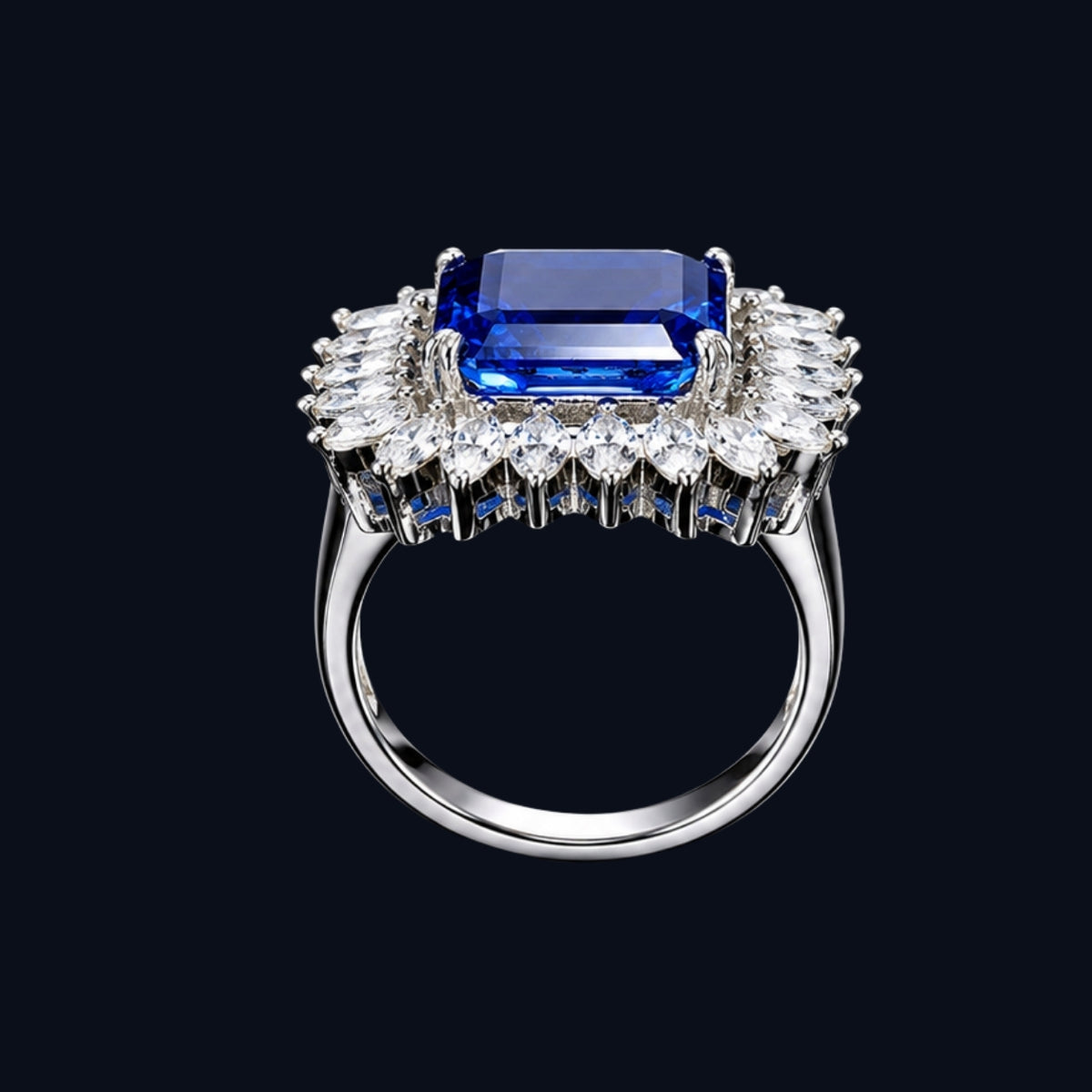 A silver tone ring with a blue gemstone and CZ stones