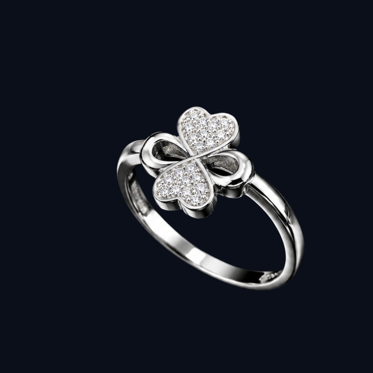 A silver ring with a four-leaf clover design and CZ stones.
