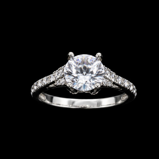 A silver-tone ring with a large round-cut CZ stone, set in a prong setting.