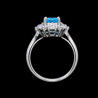 A silver-tone ring with a blue gemstone and clear gemstones