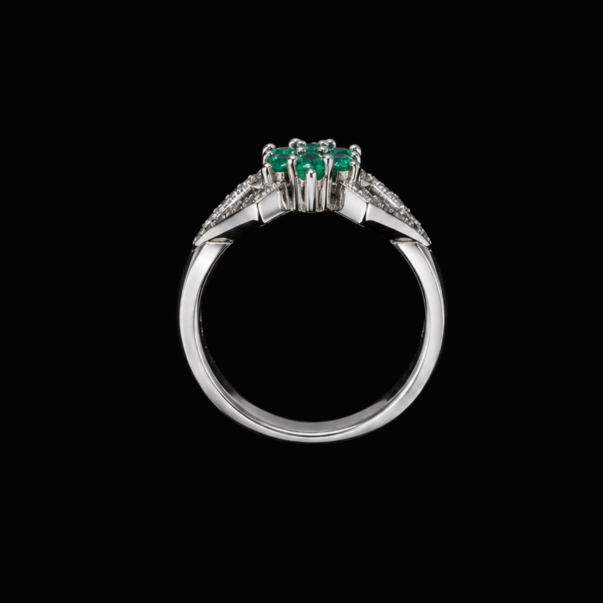 A silver-tone ring with three emerald stones and CZ accents.