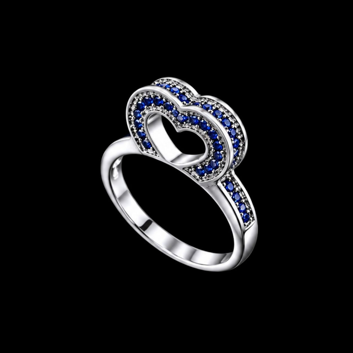 A silver-tone ring with a heart-shaped design and blue CZ stones.