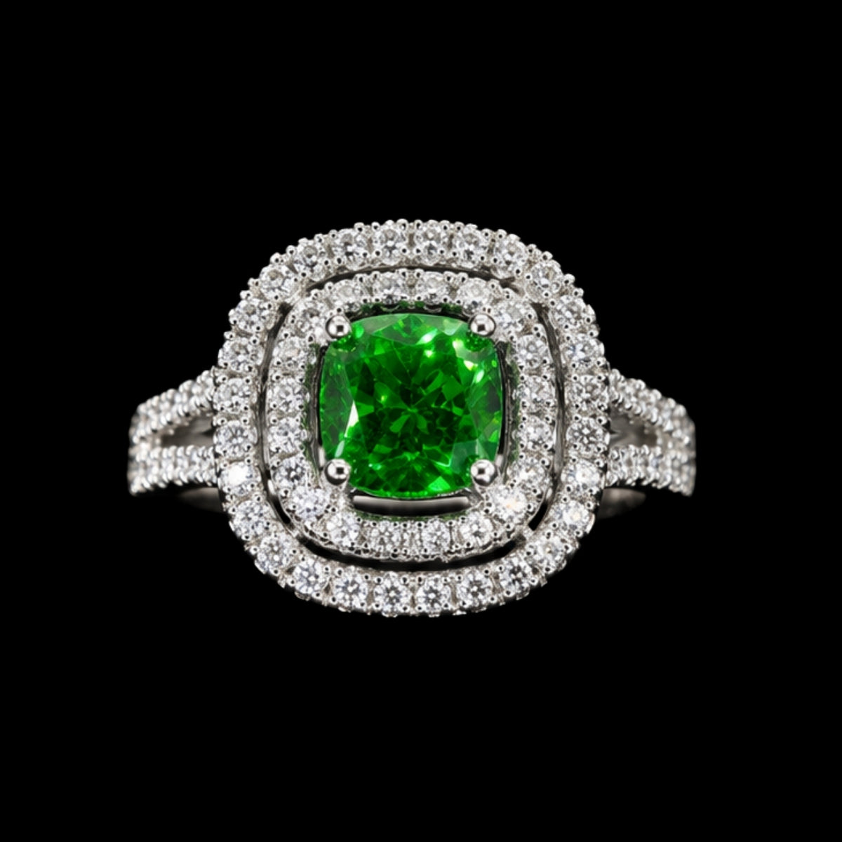 A silver ring with a green gemstone and clear CZ stones.