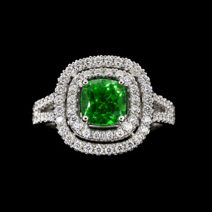 A silver ring with a green gemstone and clear CZ stones.