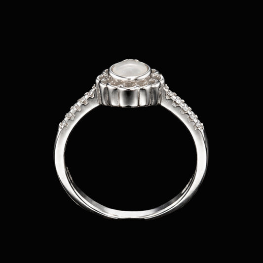 A silver ring with a central CZ stone and smaller CZ stones along the band.