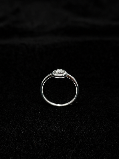 A silver ring with a round-cut CZ stone, set in a simple design.