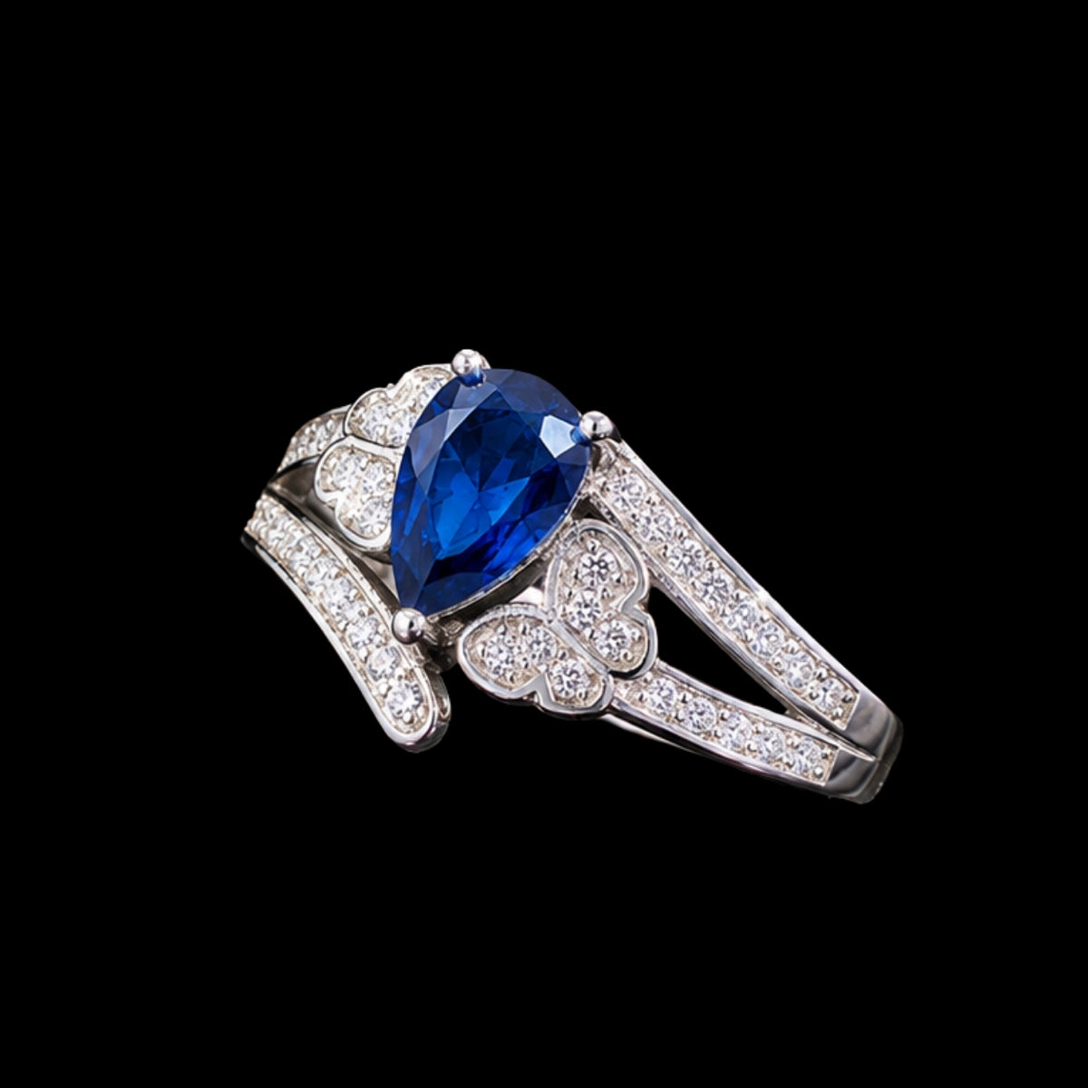 A silver tone ring with a large blue CZ stone and smaller CZ stones