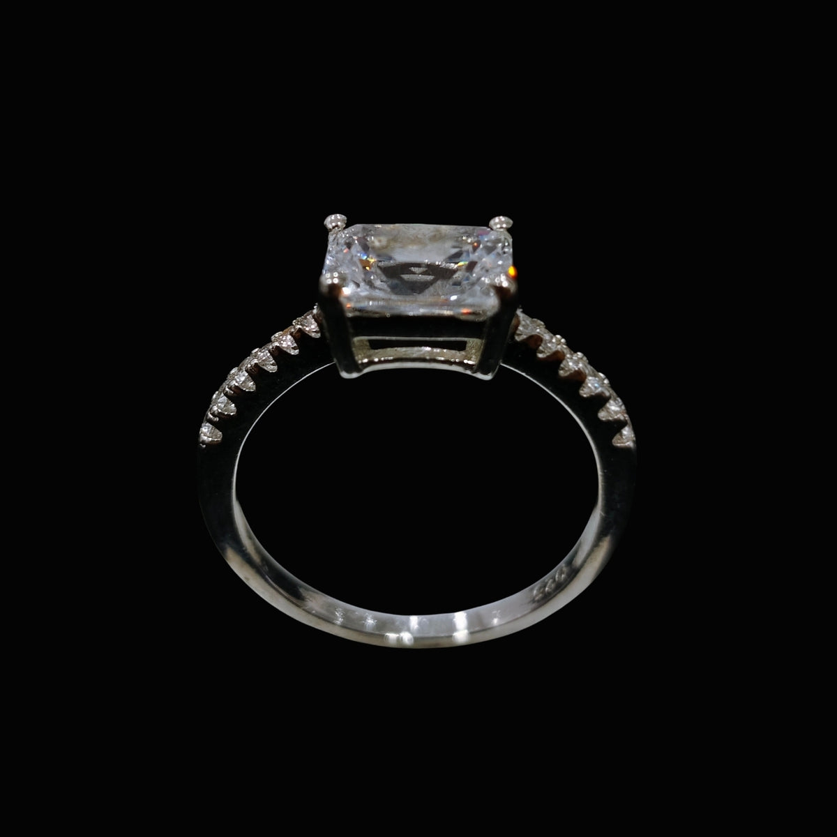 A silver-tone ring with a large, clear CZ stone set in a minimalist design.