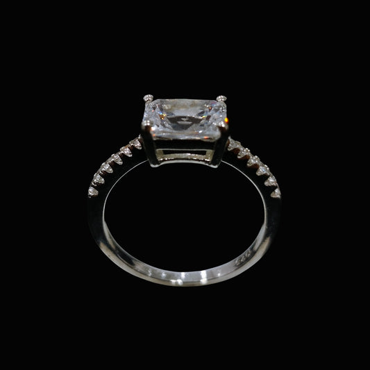 A silver-tone ring with a large, clear CZ stone set in a minimalist design.