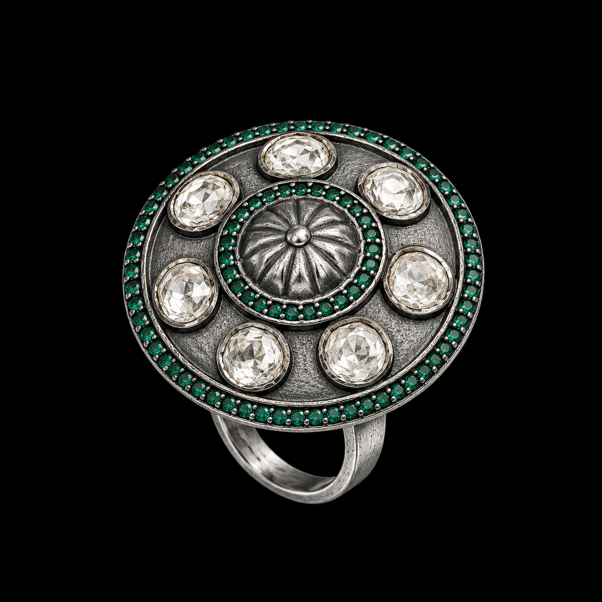 A silver-tone ring with six clear CZ stones and green enamel details.