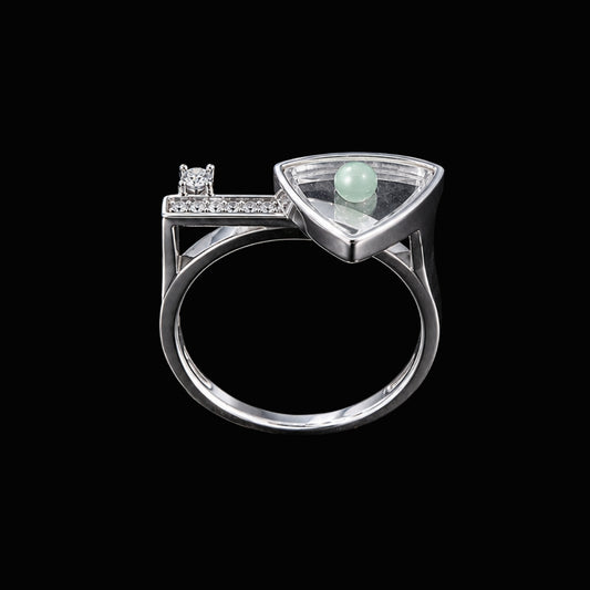 A silver ring with a trillion cut clear stone, set in a geometric design.