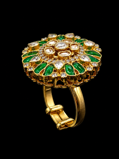 A gold ring with a floral design featuring green enamel and CZ stones.