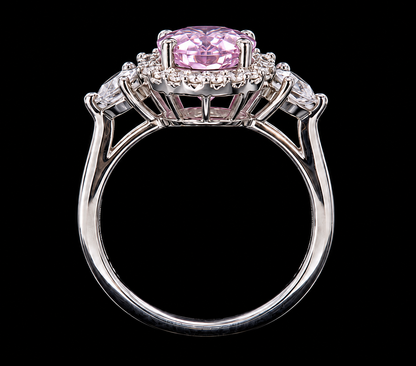 A silver ring with a pink CZ stone and clear CZ accents