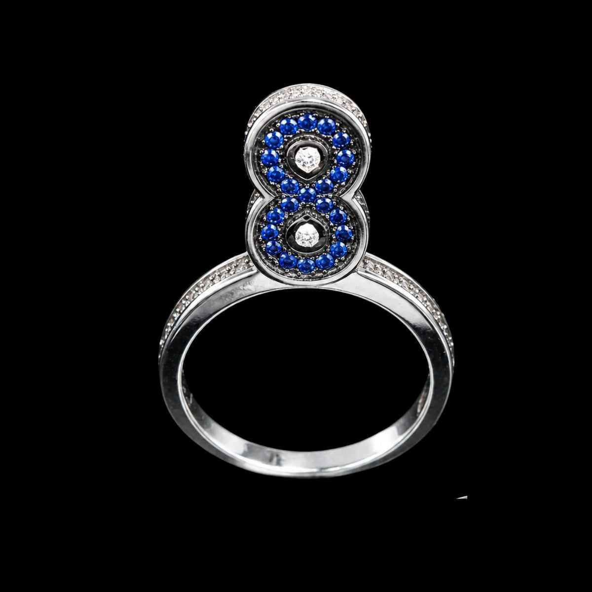 A silver-tone ring with two circles of CZ stones, set against a black background.