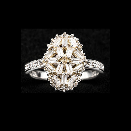 A gold-tone ring with a floral design and baguette CZ stones.