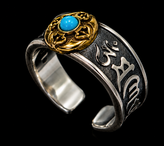 A silver ring with gold tone accents and a blue stone, featuring intricate engraved details.
