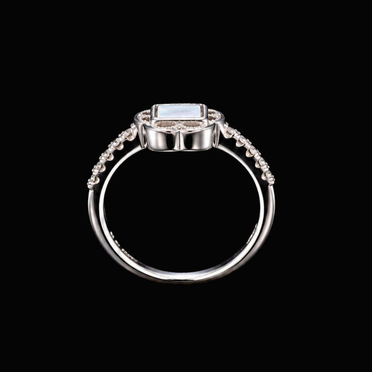 A silver ring with an enamel design and CZ stones.