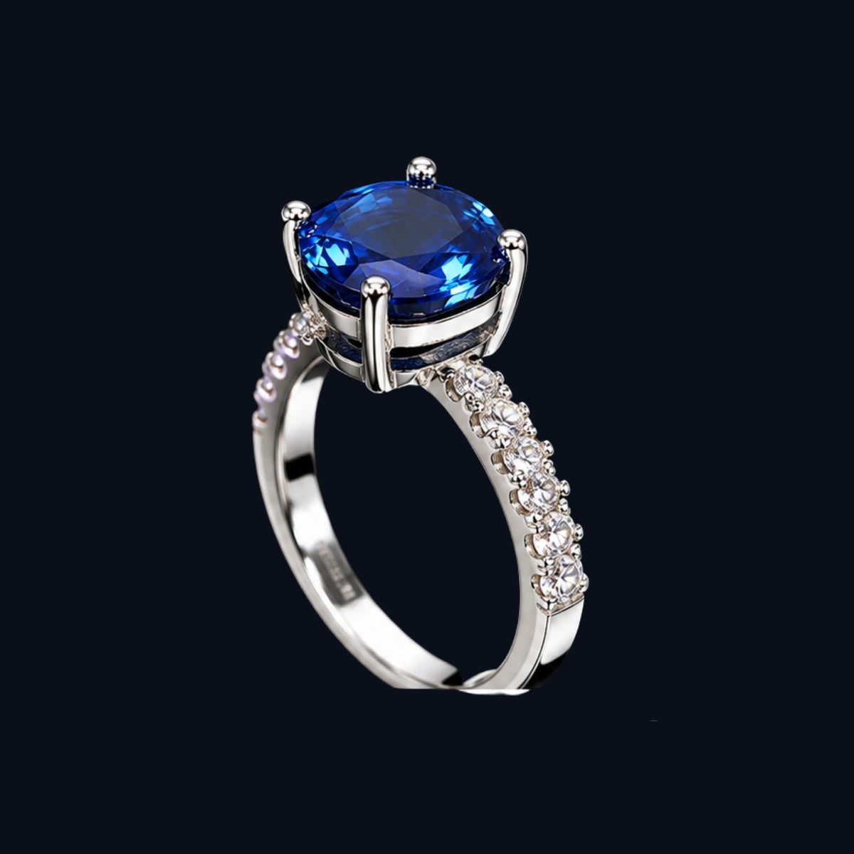A silver-tone ring with a large blue CZ stone on a black background