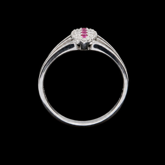 A silver ring with a cluster of pink cubic zirconia stones on a black background.