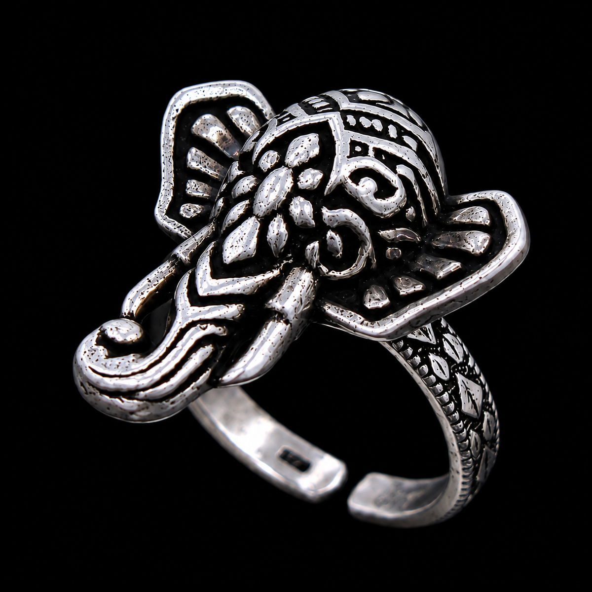 A silver ring with an engraved elephant design.