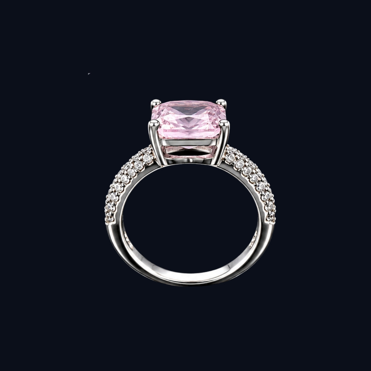 A silver-tone ring with a large pink CZ stone, set against a dark background.