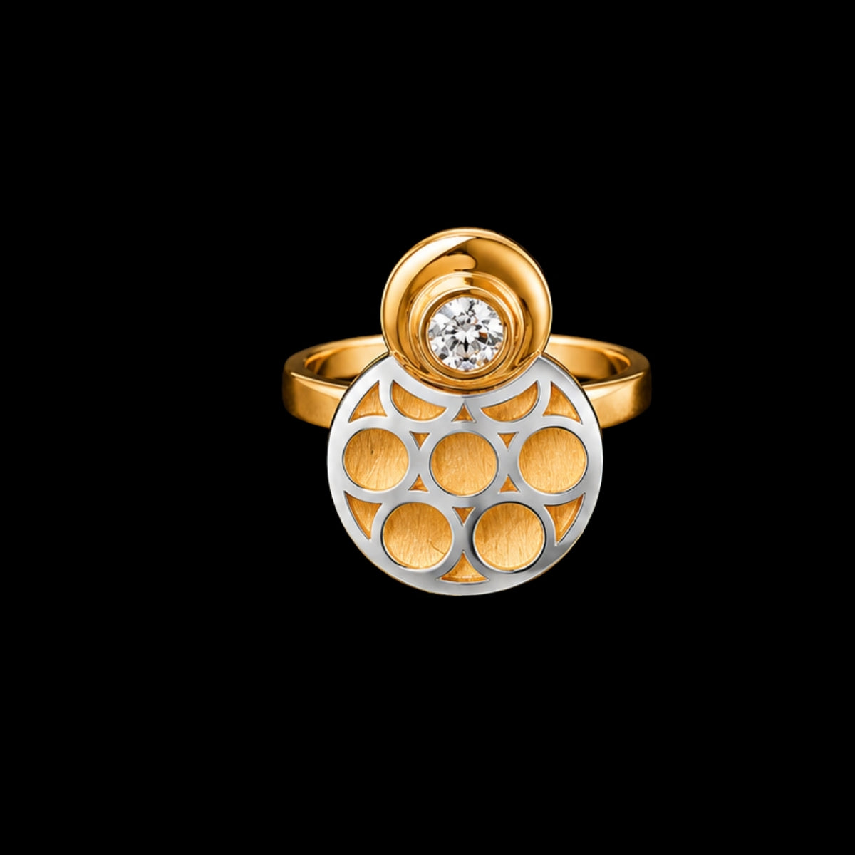 A gold and silver ring with a clear CZ stone on a black background.