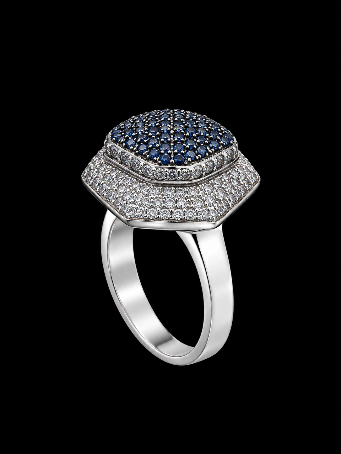 Silver ring with blue and white CZ stones on a plain background