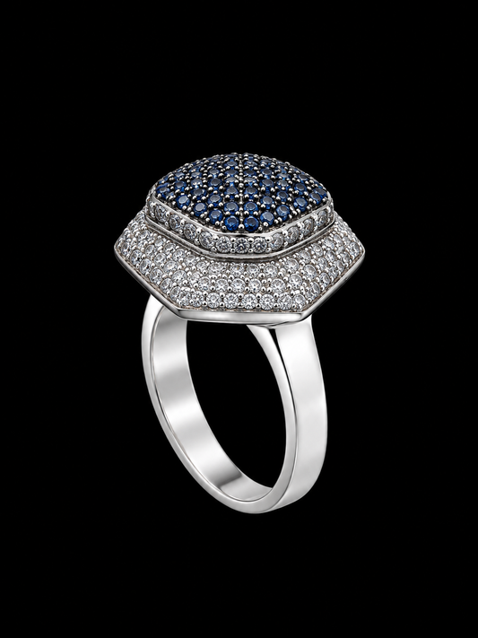 Silver ring with blue and white CZ stones on a plain background