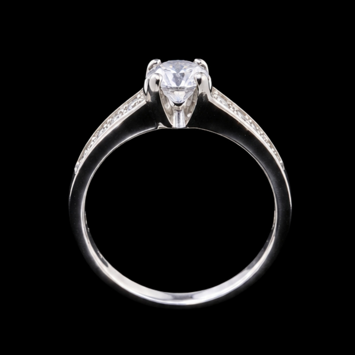 A silver ring with a round-cut CZ stone at its center, set against a plain background.